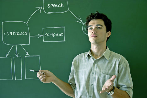 Man presenting at a chalk board saying compare and contrast
